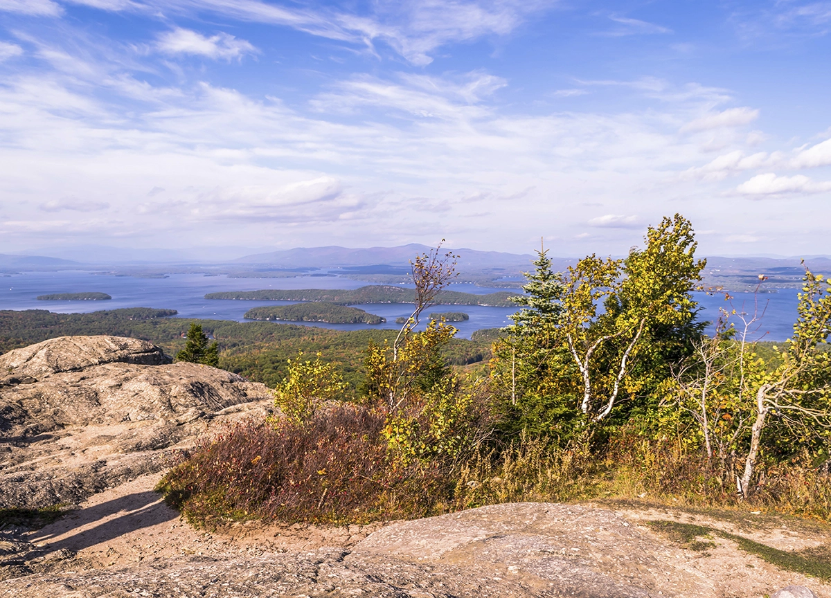 View from a rocky cliff looking out over Lake Winnipesaukee in New Hampshire. 