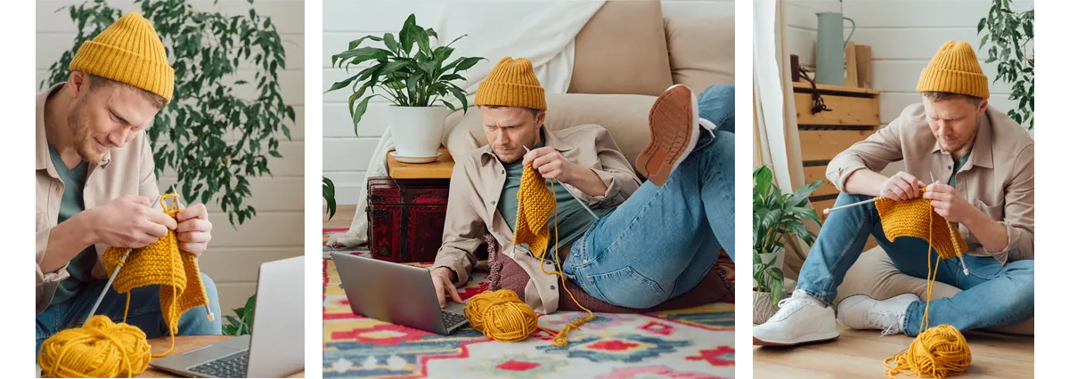 A man wearing a yellow knit hat knits with yellow yarn next to an open laptop.