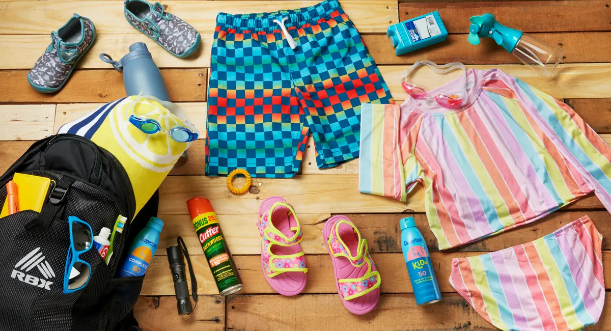 Summer camp supplies on wooden table flat lay