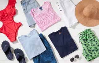 A variety of t-shirts, shorts, flip-flops, a hat, and sunglasses.