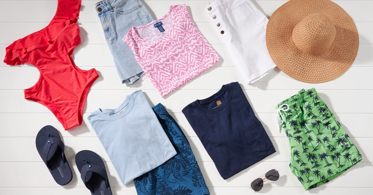 A variety of t-shirts, shorts, flip-flops, a hat, and sunglasses.