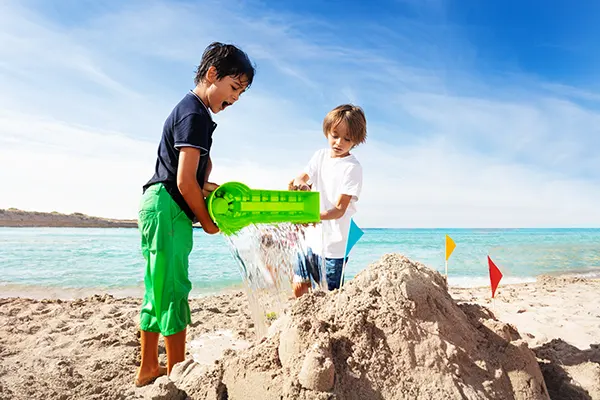 Kids building a sand castle at the beach