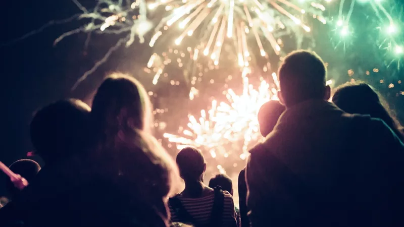 A family watches a fireworks display.