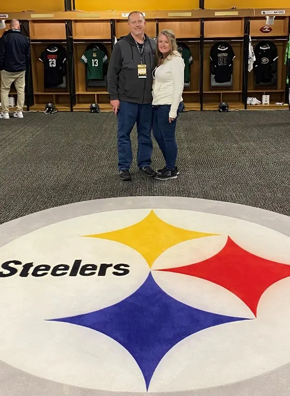 Couple standing in Steelers locker room