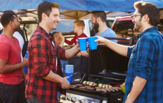 Friends talking at a tailgate party with drinks