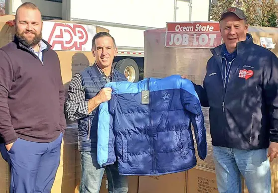 David Sarlitto, Executive Director OSJL Charitable Foundation with Brian Gates, Director Bookwell Travel, display some Buy-Give-Get Coats for veterans in need.