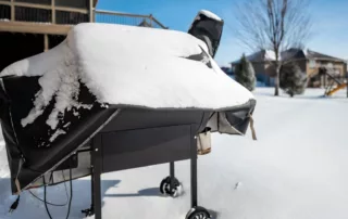 Snow-covered grill surrounded by heavy snowfall
