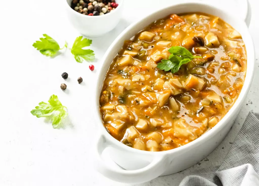 Mushroom stew in a wide white bowl.