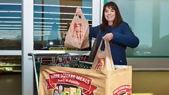 OSJL representative showing donations at Ocean State Job Lot’s Three Square Meals program donation event along with iHeartRadio in Johnston, Rhode Island in November 2022.
