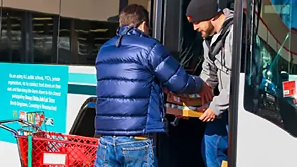 OSJL volunteers load food drive donations onto a Rhode Island Public Transportation bus.