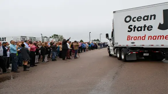 OSJL associates wave to departing trucks carrying donated food to area partners.