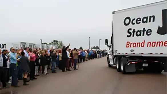 OSJL associates wave to departing trucks carrying donated food to area partners.