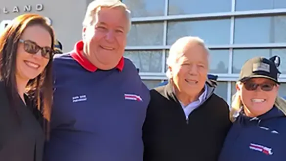OSJL associate Alison White; Don Cox, President of Massachusetts Military Support Foundation; Robert Kraft, CEO of The Kraft Group; and a volunteer from Massachusetts Military Support Foundation at an event at Gillette Stadium.