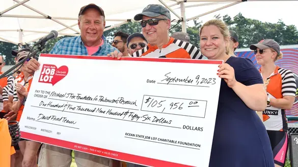 Ocean State Job Lot Charitable Foundation Executive Director David Sarlitto presents a check to The New England Parkinson’s Ride in Old Orchard Beach, Maine to benefit The Michael J. Fox Foundation for Parkinson’s Research
