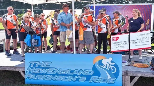 Ocean State Job Lot Charitable Foundation Executive Director David Sarlitto on stage with the members of Team Skunky at The New England Parkinson’s Ride in Old Orchard Beach, Maine