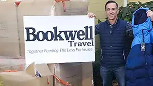 Brian Gates, of Bookwell Travel, with boxes of donated Ocean State Job Lot coats for veterans in need.