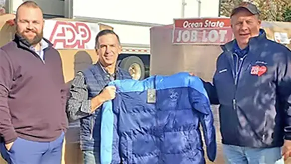 Representatives from Bookwell Travel with David Sarlitto, Executive Director of Ocean State Job Lot Charitable Foundation with coats for veterans in need.