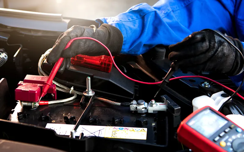 mechanic testing car battery