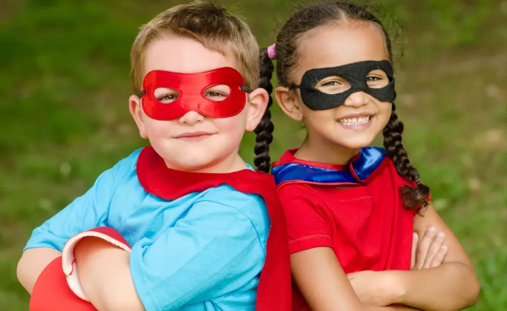 A girl and boy wearing a DIY superhero Halloween costume.