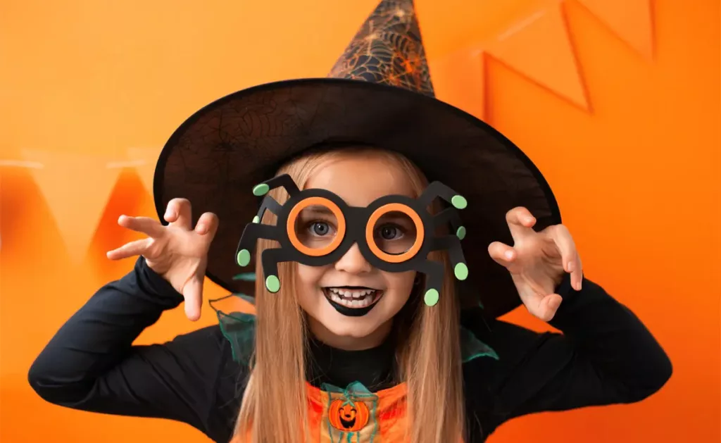 A girl wearing a DIY Halloween witch’s costume.