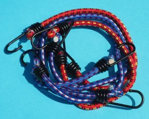 A neat pile on bungee cords on a blue background.