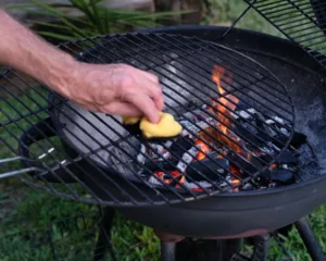 Cleaning an outdoor BBQ grill before storage.
