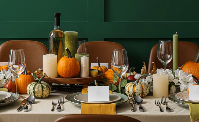 A table set and decorated for Thanksgiving dinner.