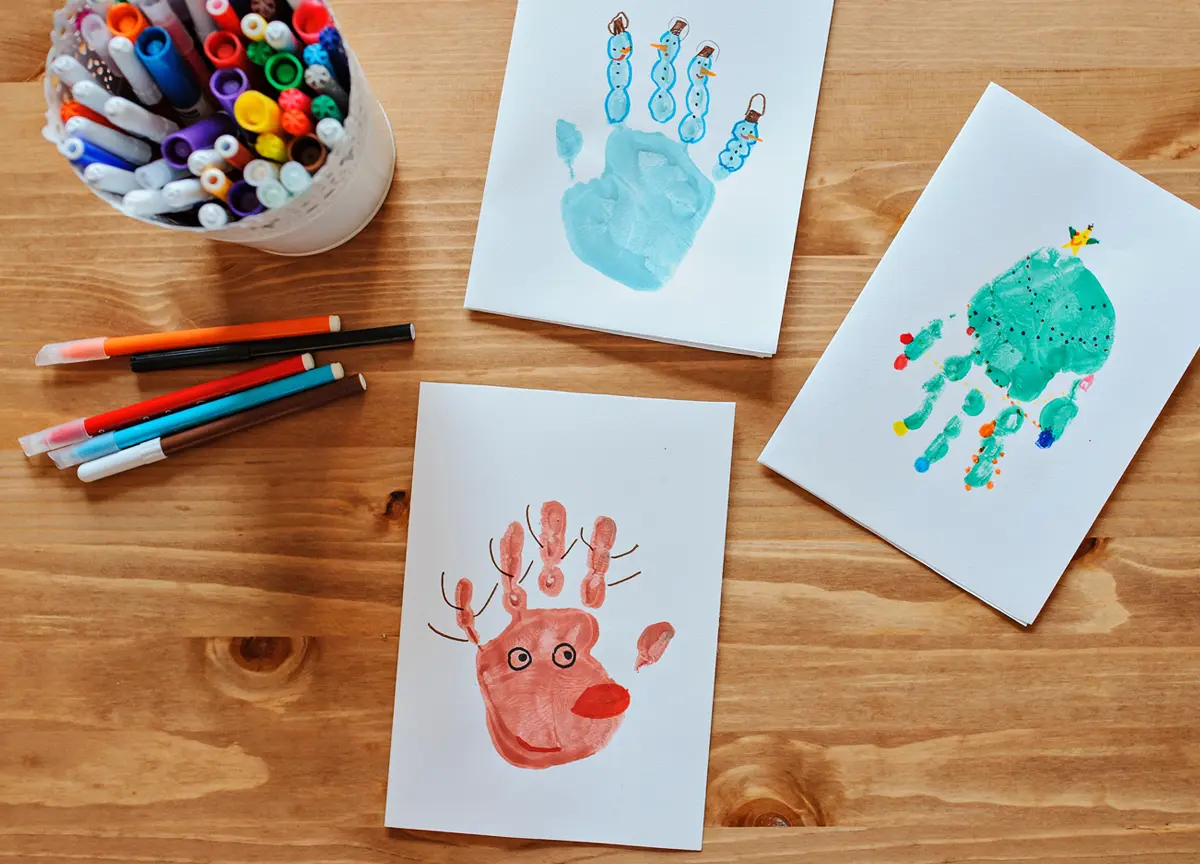 A child’s handprint is turned into a reindeer using markers and crafting accessories.
