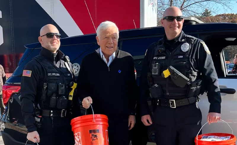 Massachusetts police officers collect buckets with Buy-Give-Get coats to distribute locally to veterans in need.