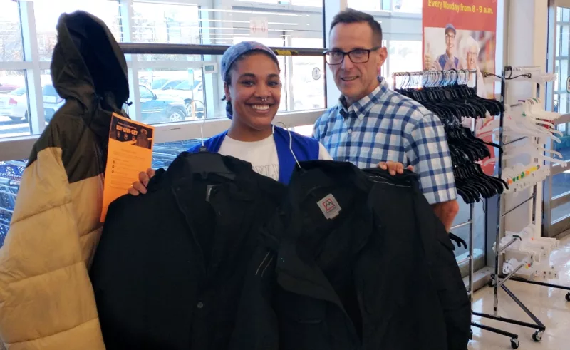 Customer Mike Marchetti with a Wilkes-Barre OSJL associate and one of the 50 coats that he purchased to donate to Kingston Rotary Club.