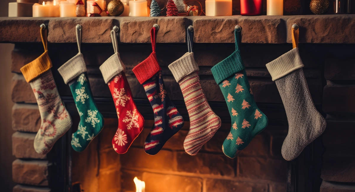 Knit stockings hang on a fireplace mantle.