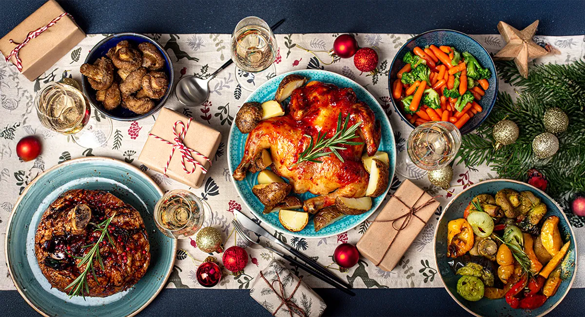 Holiday dinner table setting with food and festivities