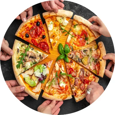 Hands reaching for slices of different kinds of pizzas.