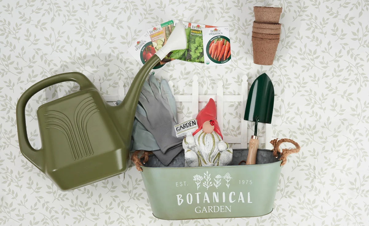 A watering can, planter, gloves, a trowel, biodegradable pots, and a garden gnome are spread out on a floral background.