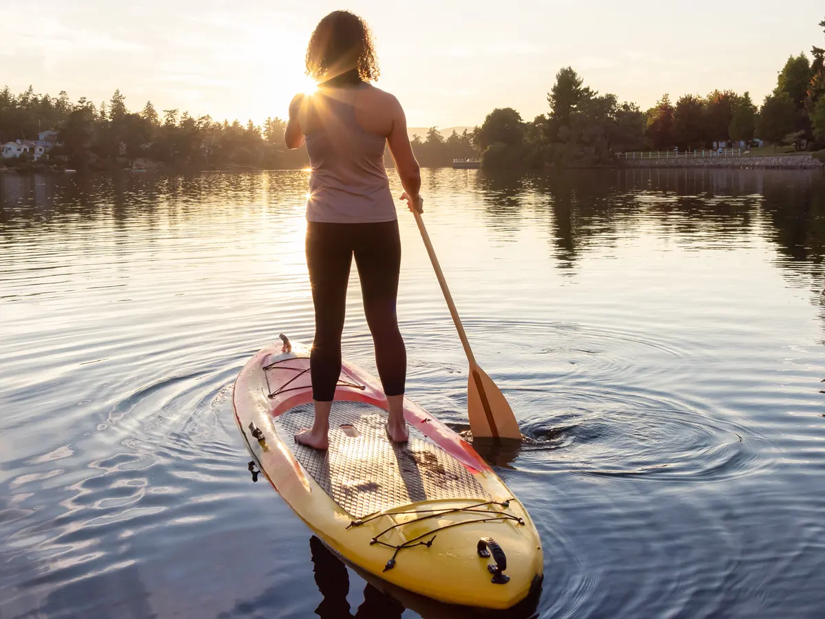 Woman paddling on peaceful lake