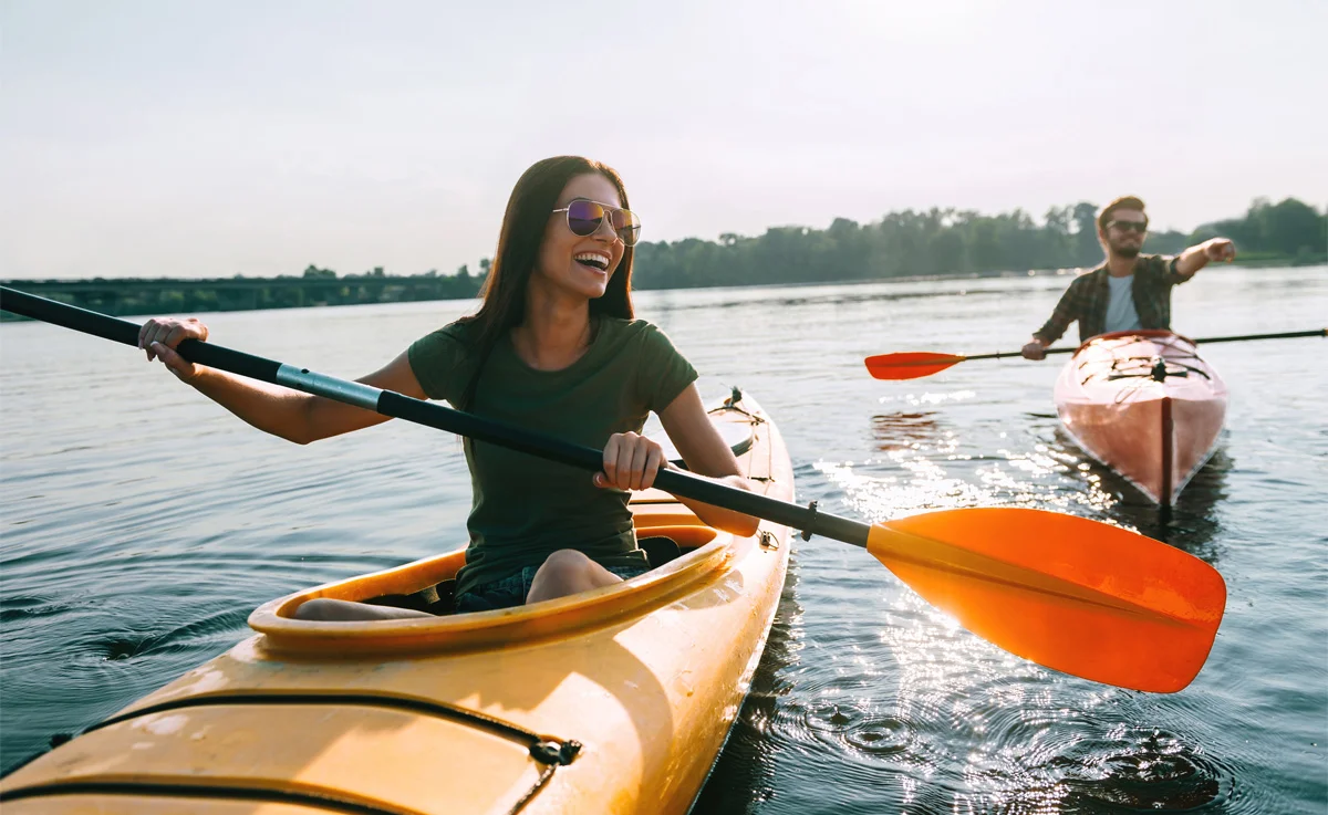 A man and a woman having fun in a kayak.