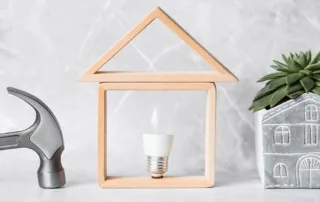 Ideas for an eco-friendly home renovation showing a light bulb, hammer and plant.