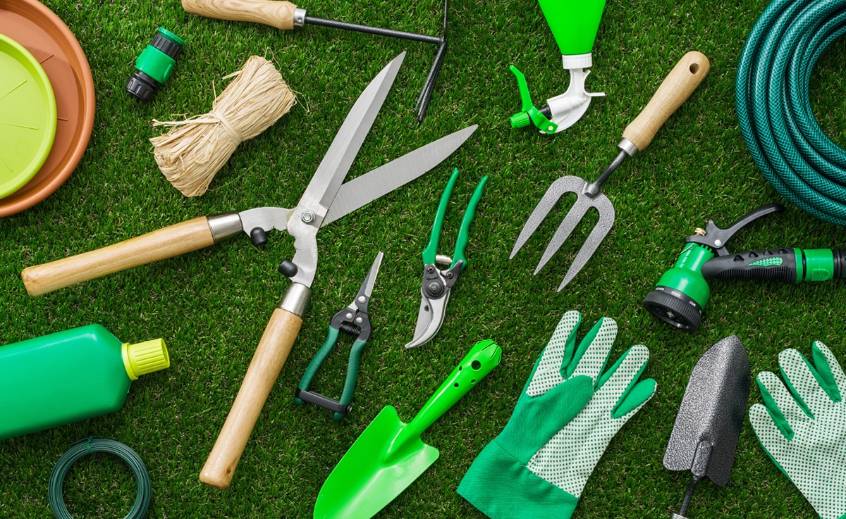 Garden tool inventory laid out on the grass.