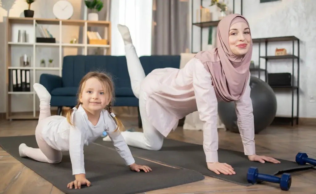 A mother and daughter doing yoga together in the living room.