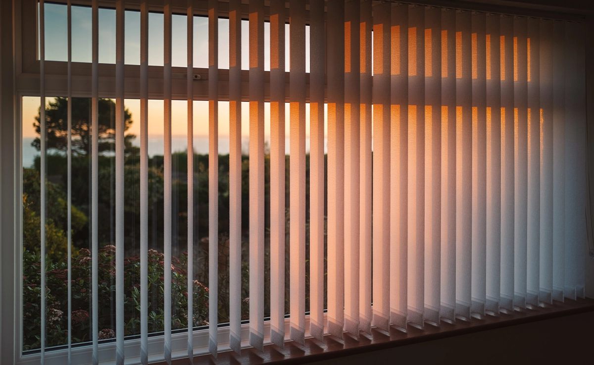 Vertical slat blinds hanging in a house.