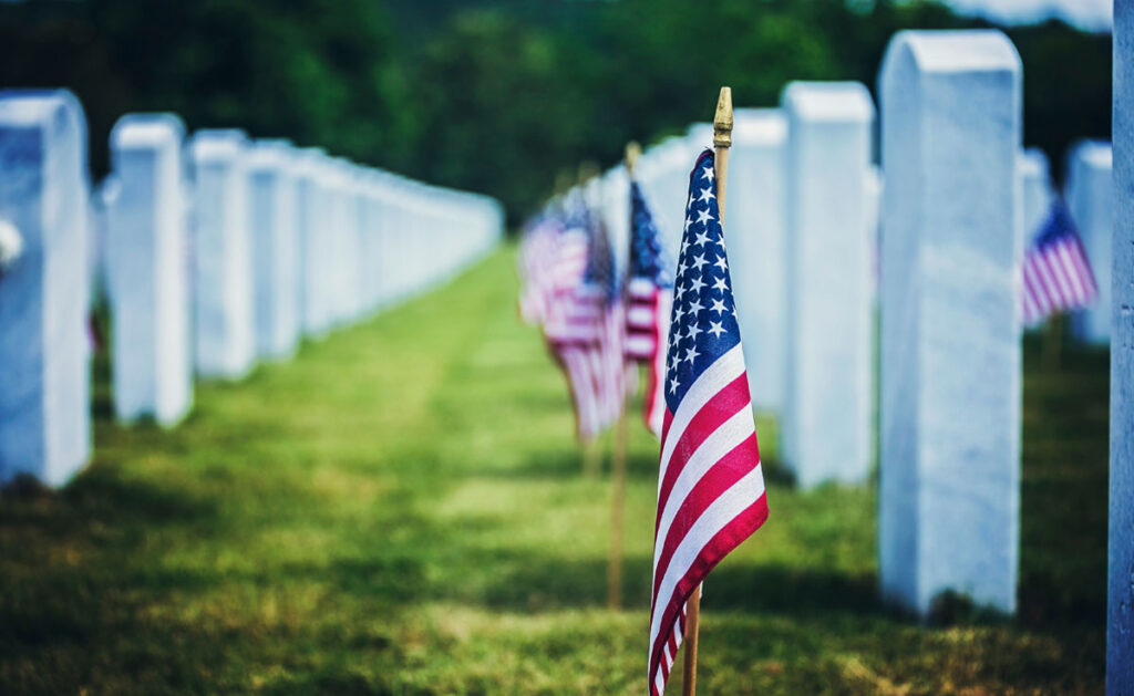 An American flag and graves at the US National Cemetery.