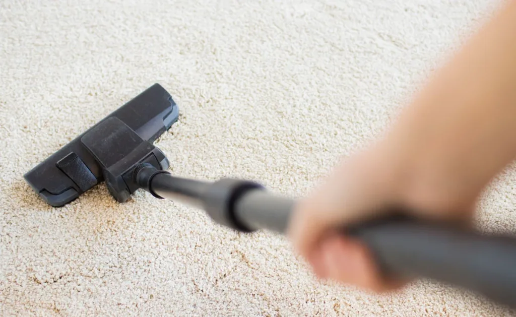 A point-of-view showing a person vacuuming a floor.