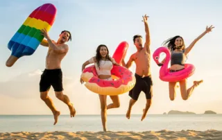 Kids jumping at the beach.