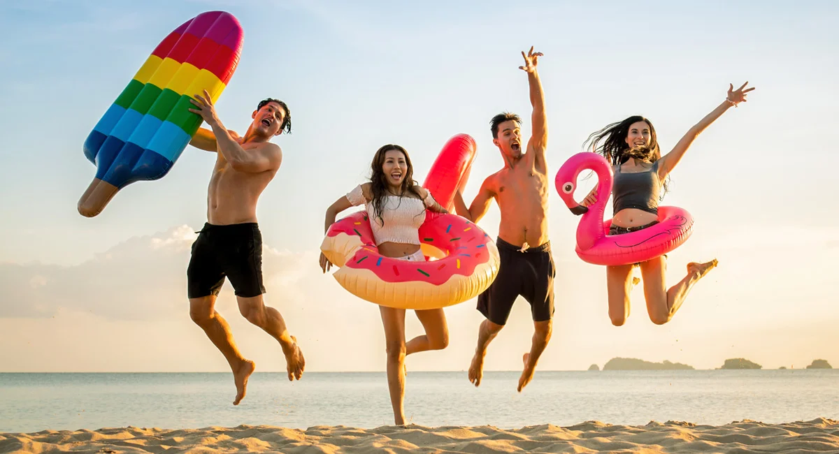 Kids jumping at the beach.