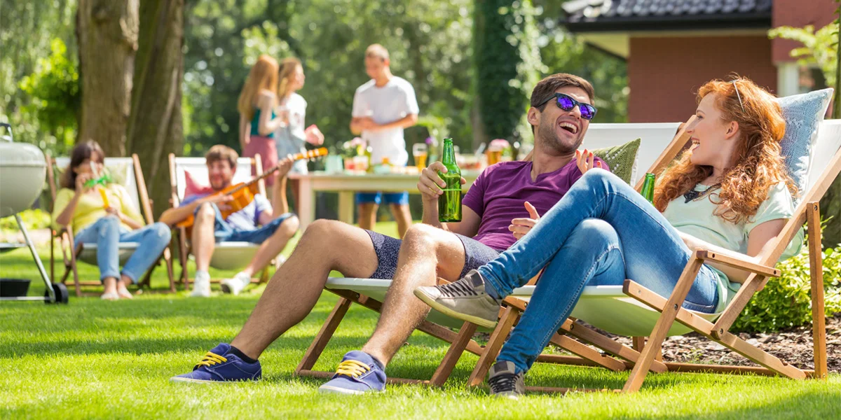 A couple having fun at a backyard summer party.