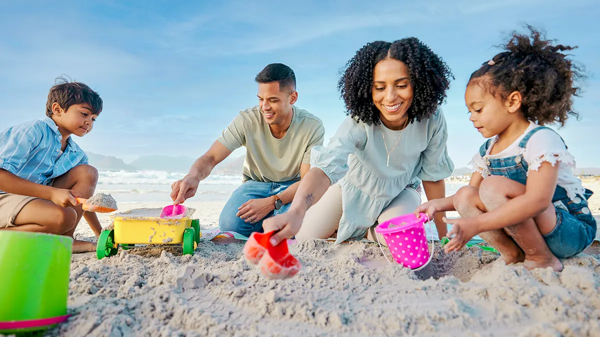 Family playing in the sand at the beach