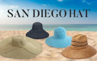 4 sun hats laying in sand on the beach