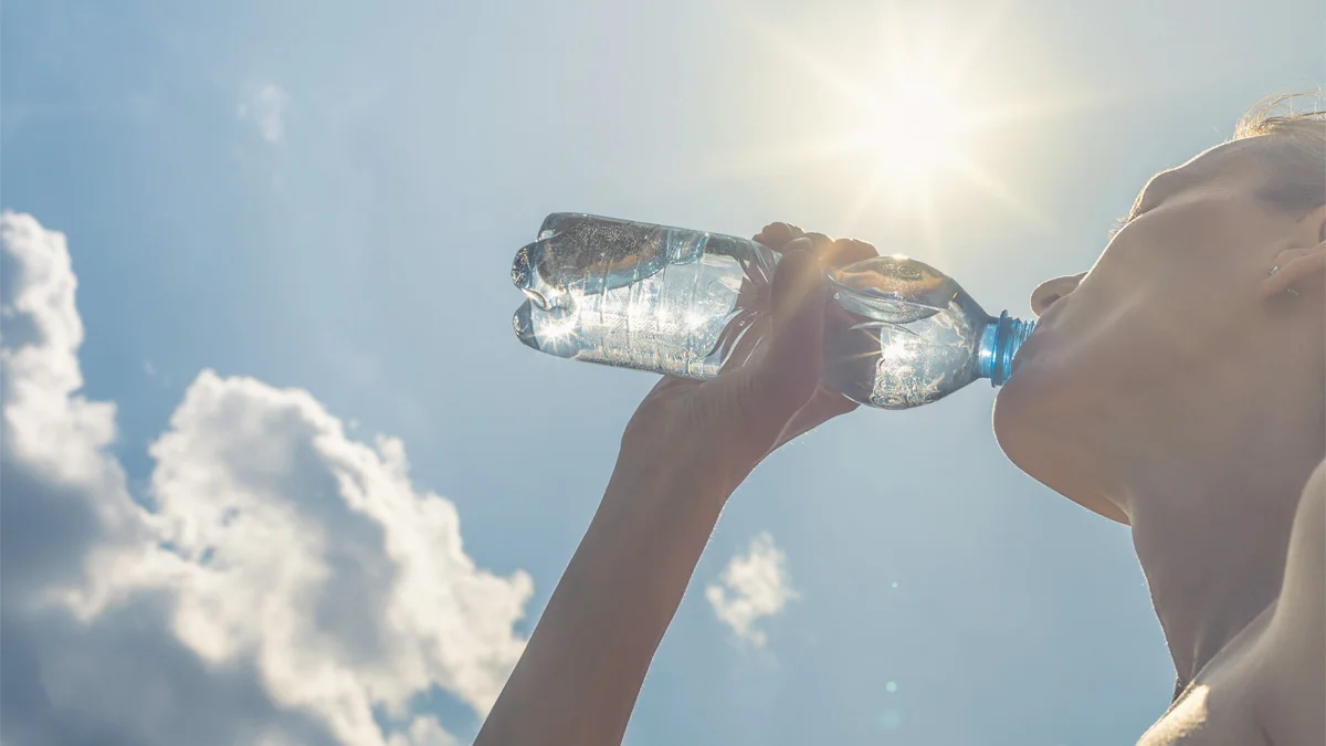 A woman drinking water.