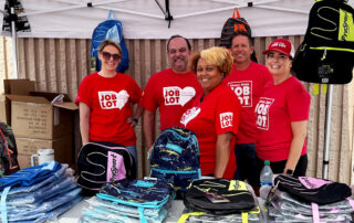 A group of Ocean State Job Lot associates helped to hand out Buy-Give-Get Backpacks to children in August 2023.