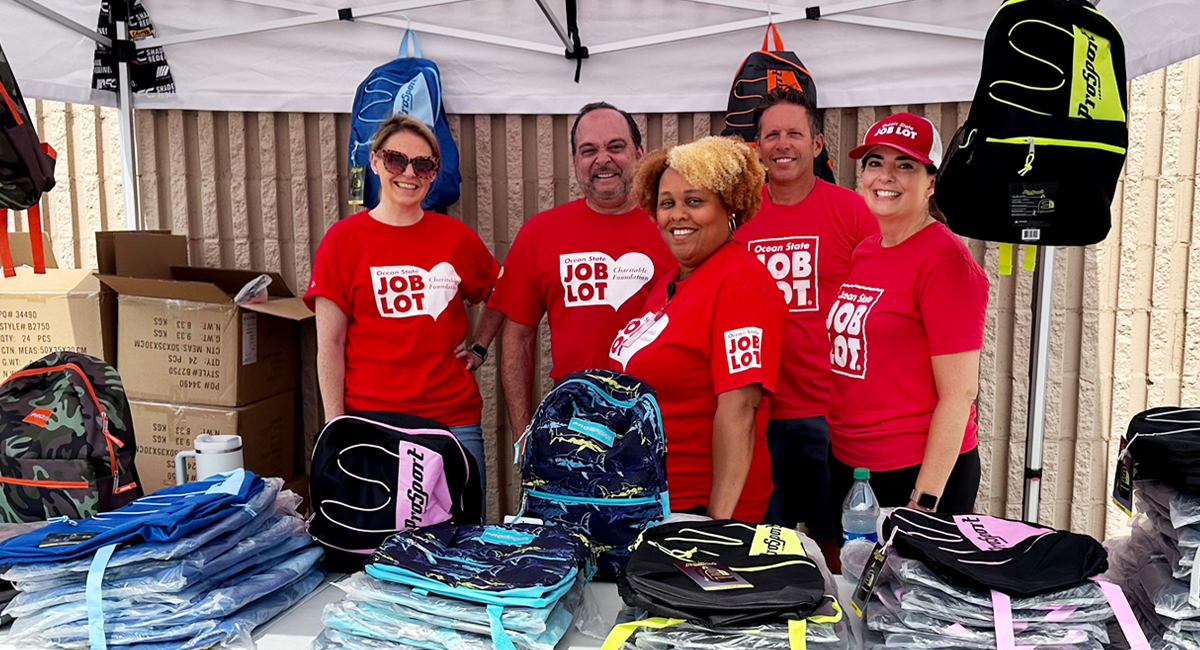 A group of Ocean State Job Lot associates helped to hand out Buy-Give-Get Backpacks to children in August 2023.